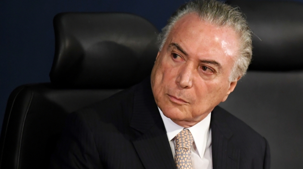 Brazilian President Michel Temer (C), Supreme Court President Carmen Lucia (L) and Brazil's new Attorney General Raquel Dodge, take their seats during the inauguration of the latter, in Brasilia on September 18, 2017.
Dodge took over to oversee an avalanche of corruption investigations, including against President Michel Temer, and promised that no one would be 