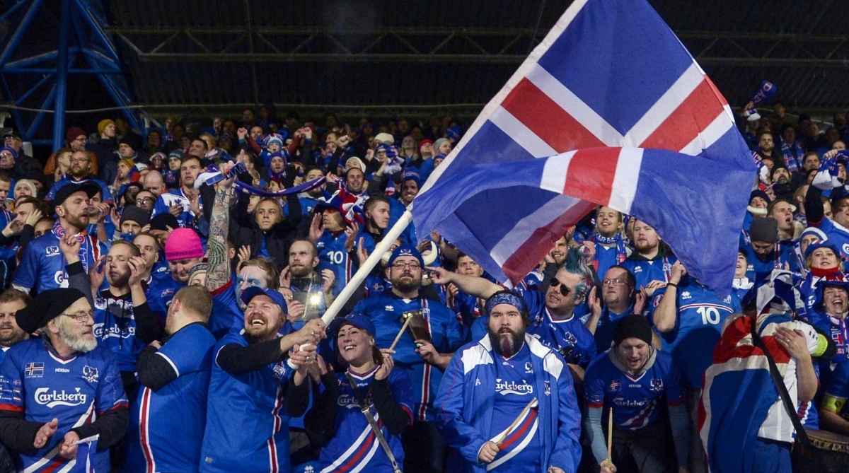 Iceland's fans celebrates at the FIFA World Cup 2018 qualification football match between Iceland and Kosovo in Reykjavik, Iceland on October 9, 2017.
Iceland qualified for the FIFA World Cup 2018 as smallest country ever after beating Kosovo 2-0 at home in Reykjavik. / AFP PHOTO / Haraldur Gudjonsson / ALTERNATIVE CROP