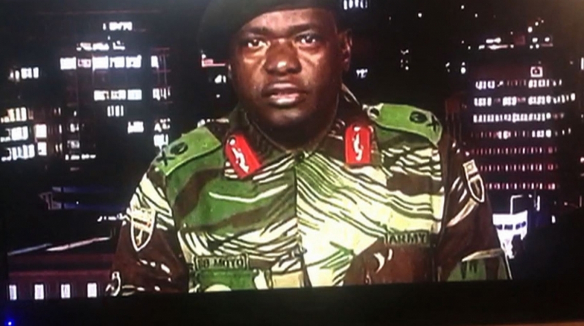 A video grab made on November 15, 2017 from footage of the broadcast of Zimbabwe Broadcasting corporation (ZBC) being shown on a television screen of Zimbabwe Major General Sibusiso Moyo reading a statement at the ZBC broadcast studio in Harare.
Zimbabwe's military appeared to be in control of the country on November 15 as generals denied staging a coup but used state television to vow to target 