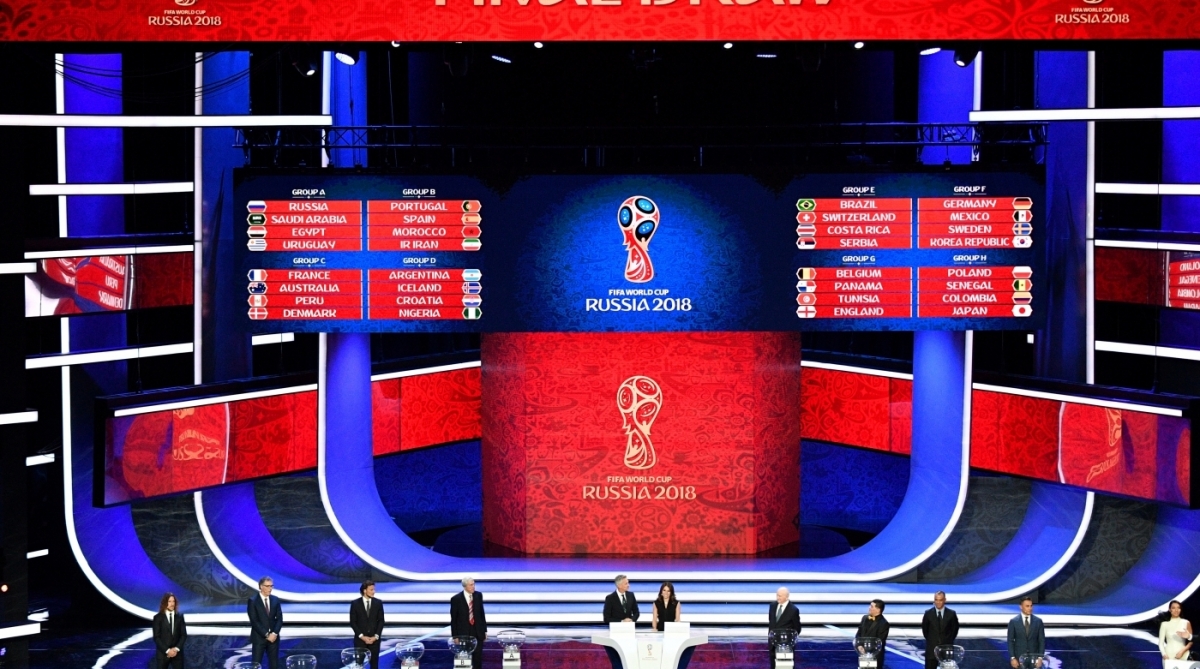 A picture shows a general view with the groups displayed on screens after   the Final Draw for the 2018 FIFA World Cup football tournament at the State Kremlin Palace in Moscow on December 1, 2017.
The 2018 FIFA World Cup will be held from June 14 and July 15, 2018, in 11 Russian cities. / AFP PHOTO / Mladen ANTONOV