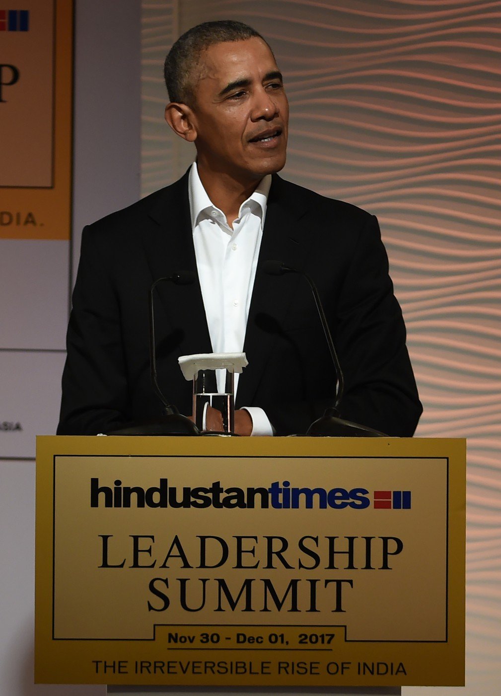 Former US president Barack Obama speaks during his address at the Hindustan Times Leadership Summit in the Indian capital New Delhi on December 1, 2017. Former US president Barack Obama launched a veiled barb at his successor Donald Trump on November 1, saying there is " a pause in American leadership"  on climate change.  / AFP PHOTO / MONEY SHARMA Caption