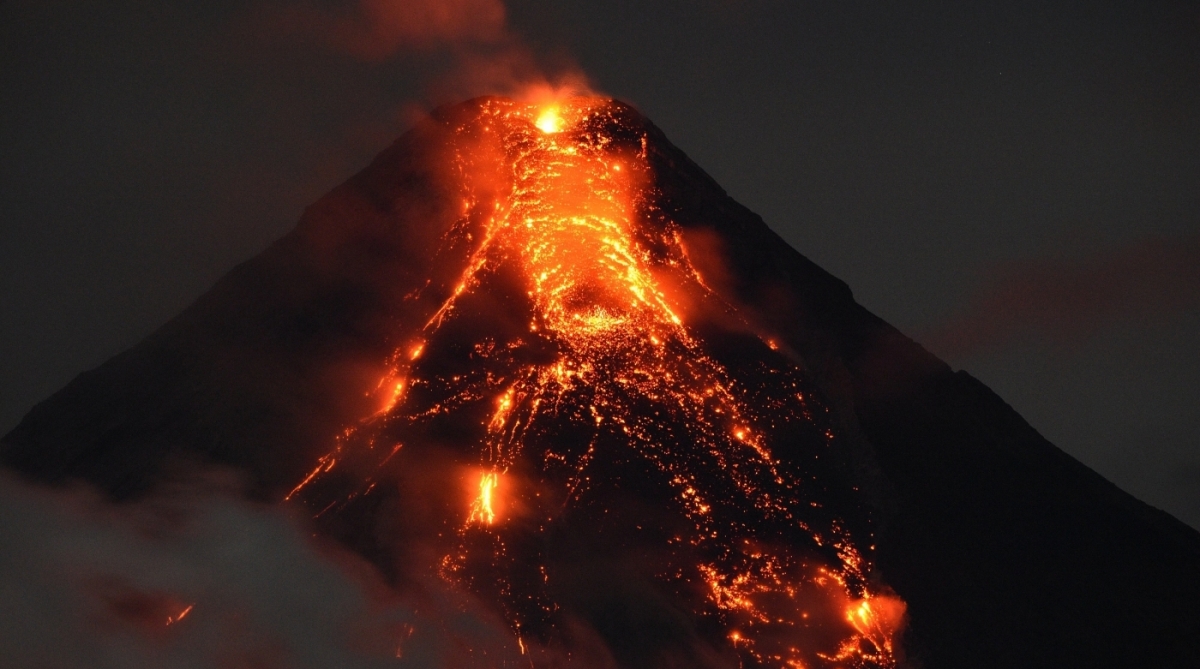 Lave flows from Mayon volcano at it continues to erupt as seen from Legazpi in Albay province, south of Manila, on January 25, 2018. 
Philippine authorities who have declared a no-go zone around an erupting volcano said January 25 they will remove all holdouts, by force if necessary, to avoid casualties after tens of thousands of other residents fled to safety. / AFP PHOTO / TED ALJIBE
      Caption