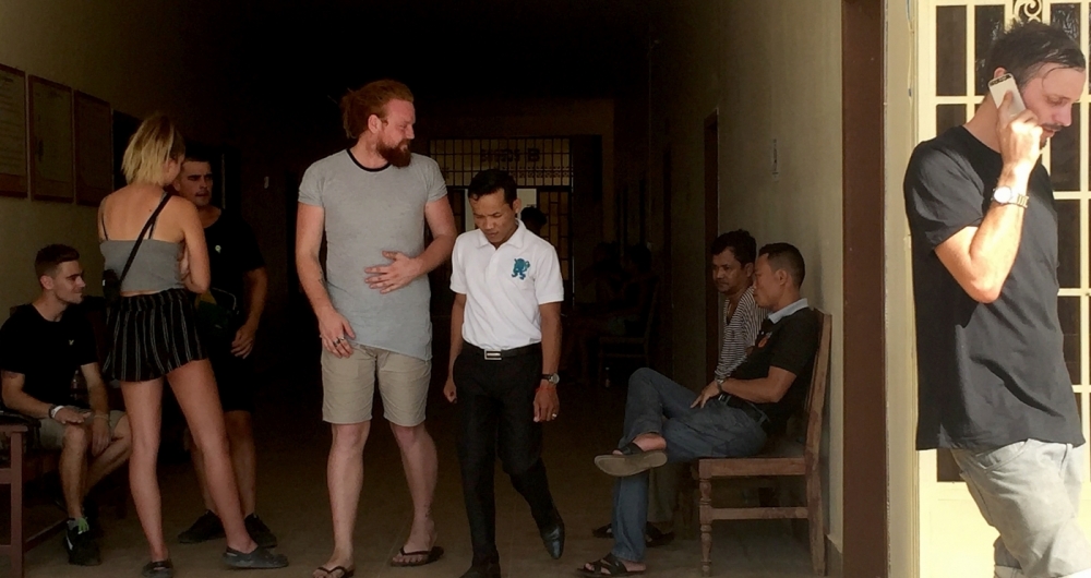 This photo taken on January 27, 2018 shows a group of foreigners outside a courtroom in Siem Reap province, some who were reportedly arrested on January 25 for allegedly 