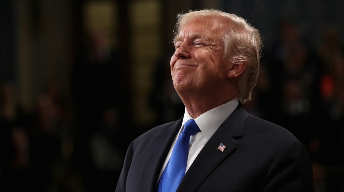 US President Donald Trump smiles during the State of the Union address in the chamber of the US House of Representatives on January 30, 2018 in Washington, DC.  / AFP PHOTO / POOL / Win McNamee