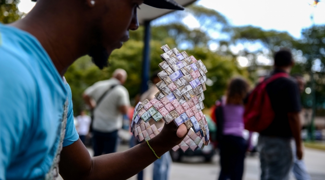 A crise econ�mica e a desvaloriza��o da moeda na Venezuela levaram um artista de rua a tentar ganhar a vida usando c�dulas como mat�ria prima para artesanato. Wilmer Rojas, 25 anos, come�ou com barquinhos e hoje produz carteiras e outros objetos. Nas pe�as ele usa at� 800 c�dulas que, juntas, comprariam um quilo de arroz. 