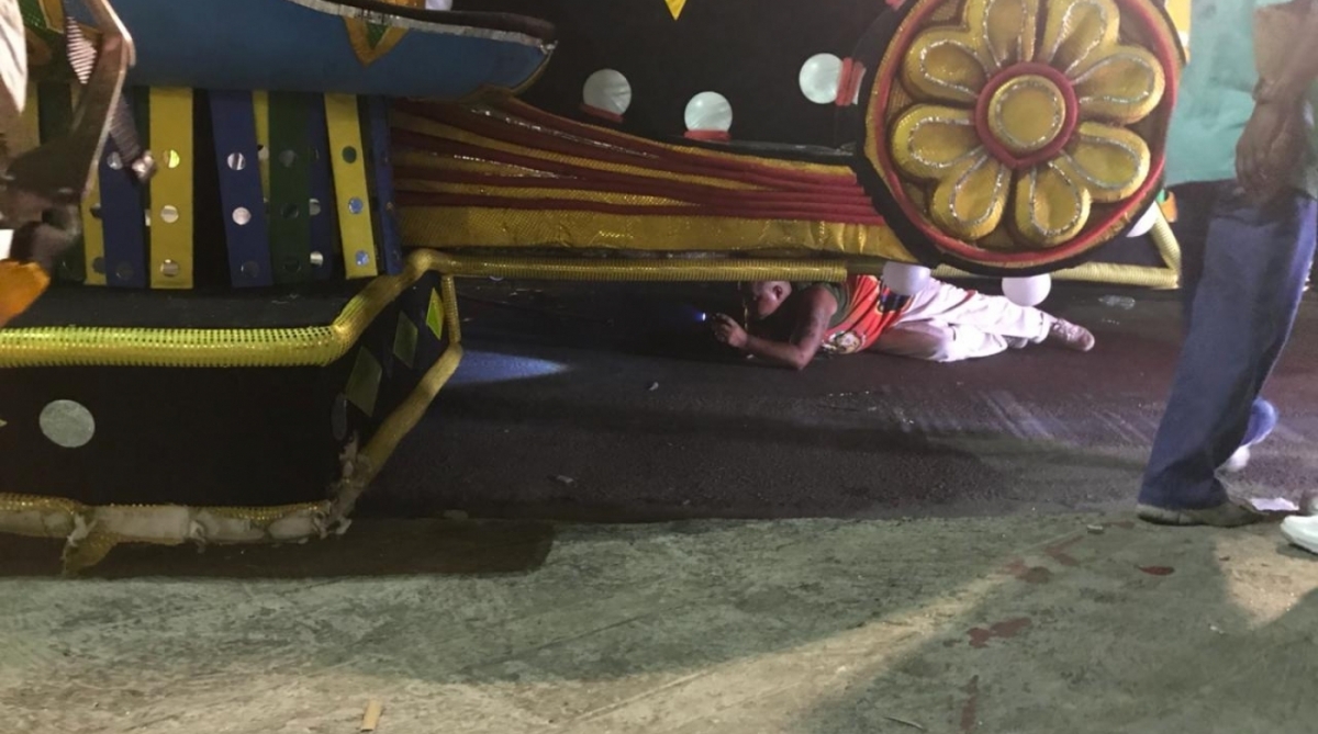 Homem tenta consertar carro da Grande Rio