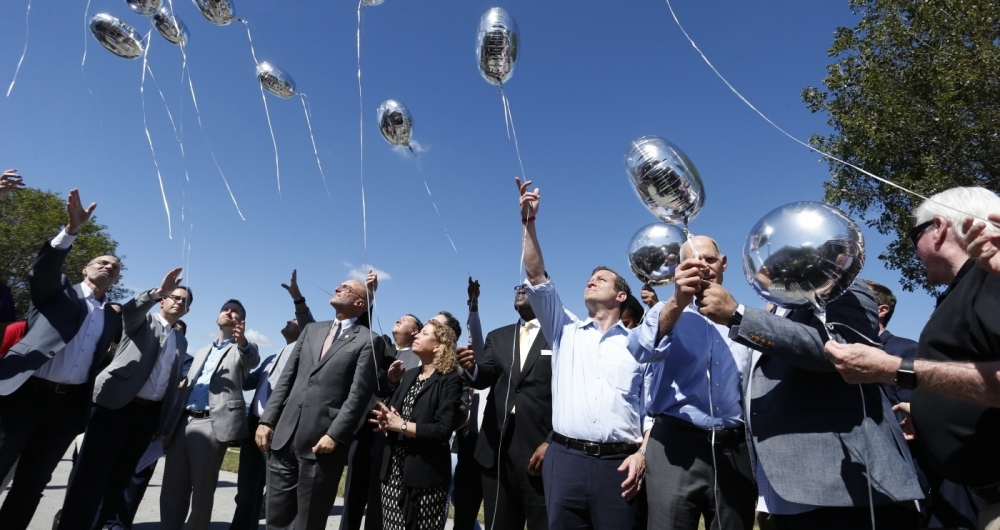 City, county and state officials release balloons in honor of the victims during a prayer vigil for the Marjory Stoneman Douglas High School shooting at Parkridge Church in Coral Springs, Florida on February 15, 2018. 
The heavily armed teenager who gunned down students and adults at a Florida high school was charged Thursday with 17 counts of premeditated murder, court documents showed.Nikolas Cruz, 19, killed fifteen people in a hail of gunfire at Marjory Stoneman Douglas High School in Parkland, Florida. Two others died of their wounds later in hospital, the sheriff's office said.
 / AFP PHOTO / RHONA WISE
      Caption