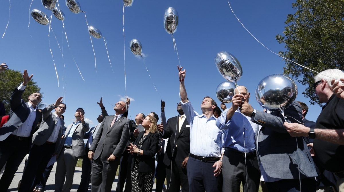 City, county and state officials release balloons in honor of the victims during a prayer vigil for the Marjory Stoneman Douglas High School shooting at Parkridge Church in Coral Springs, Florida on February 15, 2018. 
The heavily armed teenager who gunned down students and adults at a Florida high school was charged Thursday with 17 counts of premeditated murder, court documents showed.Nikolas Cruz, 19, killed fifteen people in a hail of gunfire at Marjory Stoneman Douglas High School in Parkland, Florida. Two others died of their wounds later in hospital, the sheriff's office said.
 / AFP PHOTO / RHONA WISE
      Caption - AFP/RHONA WISE
