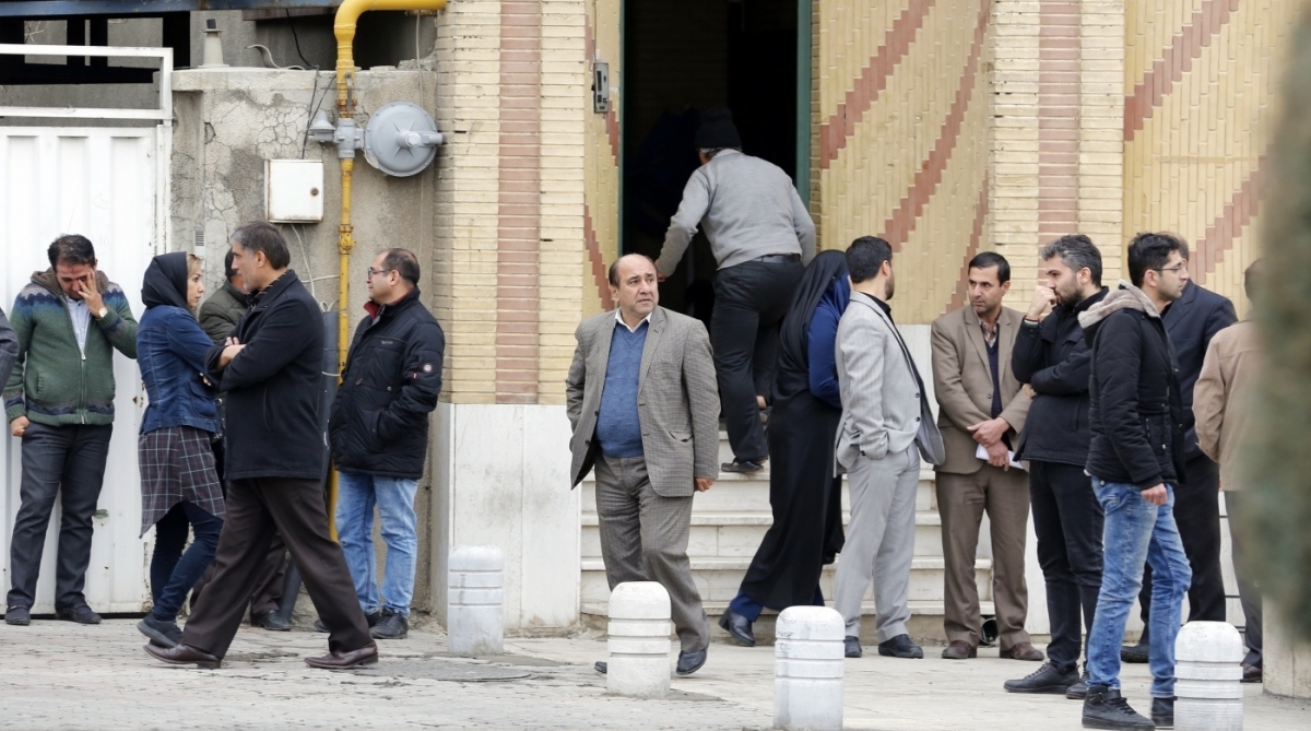 Relatives of Iranian passengers, onboard the Aseman Airlines flight EP3704, react as they gather in front of a mosque near Tehran's Mehrabad airport on February 18, 2018. 
All 66 people on board an Iranian passenger plane were feared dead after it crashed into the country's Zagros mountains, with emergency services struggling to locate the wreckage in blizzard conditions.  / AFP PHOTO / ATTA KENARE
      Caption