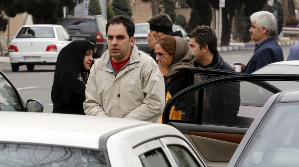 Relatives of Iranian passengers, onboard the Aseman Airlines flight EP3704, react as they gather in front of a mosque near Tehran's Mehrabad airport on February 18, 2018. 
All 66 people on board an Iranian passenger plane were feared dead after it crashed into the country's Zagros mountains, with emergency services struggling to locate the wreckage in blizzard conditions.  / AFP PHOTO / ATTA KENARE
      Caption
