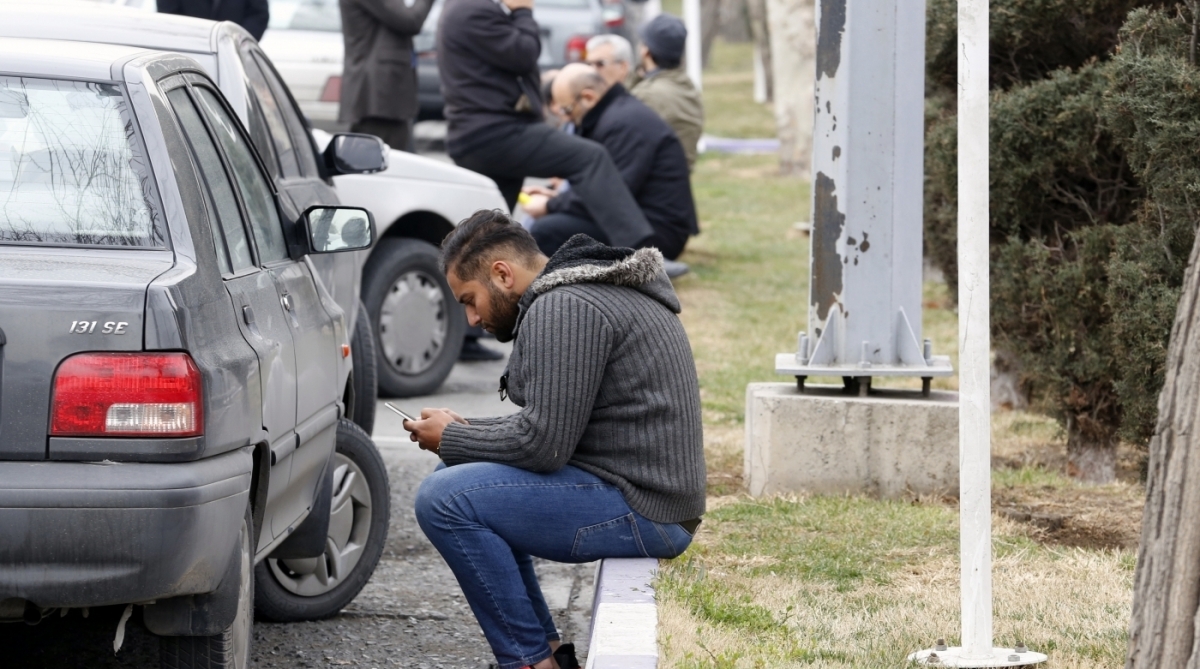 Relatives of Iranian passengers, onboard the Aseman Airlines flight EP3704, react as they gather in front of a mosque near Tehran's Mehrabad airport on February 18, 2018. 
All 66 people on board an Iranian passenger plane were feared dead after it crashed into the country's Zagros mountains, with emergency services struggling to locate the wreckage in blizzard conditions.  / AFP PHOTO / ATTA KENARE
      Caption