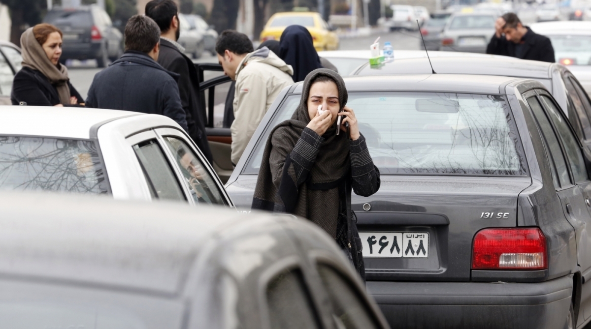 Relatives of Iranian passengers, onboard the Aseman Airlines flight EP3704, react as they gather in front of a mosque near Tehran's Mehrabad airport on February 18, 2018. 
All 66 people on board an Iranian passenger plane were feared dead after it crashed into the country's Zagros mountains, with emergency services struggling to locate the wreckage in blizzard conditions.  / AFP PHOTO / ATTA KENARE
      Caption