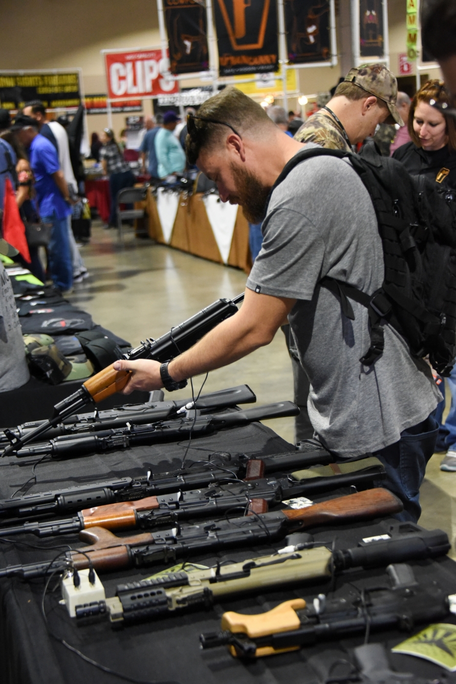 A gun enthusiast checks a weapon at the South Florida Gun Show at Dade County Youth Fairgrounds in Miami, Florida, on February 17, 2018.
The gun show started three days after a mass shooting 30 miles (48kms) away at the Marjory Douglas High School in Parkland, Florida. Vendors said they were expecting a big turnout and sales, and because of the shooting there will be a panic regarding gun restrictions and new laws that could be put in place. Vendor Domingo Martin said he brought his entire stock of of 42 AR-15's, adding that he is not the only one selling the unit at the weekend show.  / AFP PHOTO / Michele Eve Sandberg