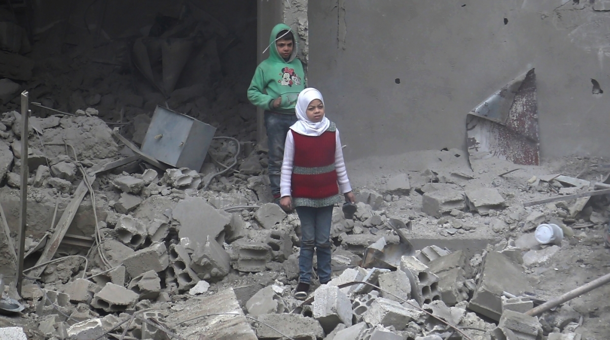 Syrian children stand amidst debris in Hamouria, in the rebel-held besieged Eastern Ghouta region on the outskirts of the capital Damascus on February 22, 2018.
The death toll for five days of bombardment by the Syrian regime and its allies on the rebel-held enclave of Eastern Ghouta passed the 400 mark today, a monitor said. / AFP PHOTO / ABDULMONAM EASSA