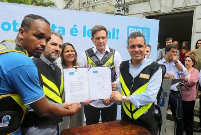 Prefeito Marcelo Crivella e o secretário de Transportes, Rubens Teixeira, na solenidade de assinatura do decreto que regulamenta a profissão de mototaxista