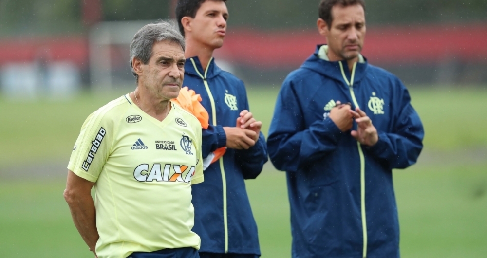 Pensativo, Carpegiani observa o treino do Flamengo no Ninho do Urubu
