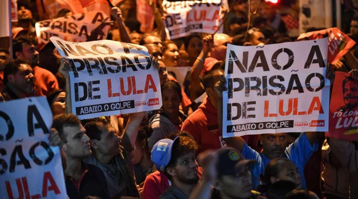 Supporters of former president (2003-2011) Luiz Inacio Lula da Silva hold signs reading 