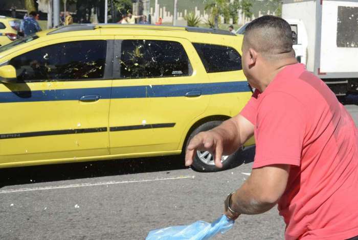 Manifestante, em frente à sede da prefeitura, arremessa ovo em carro de taxista que não quis aderir ao protesto ontem