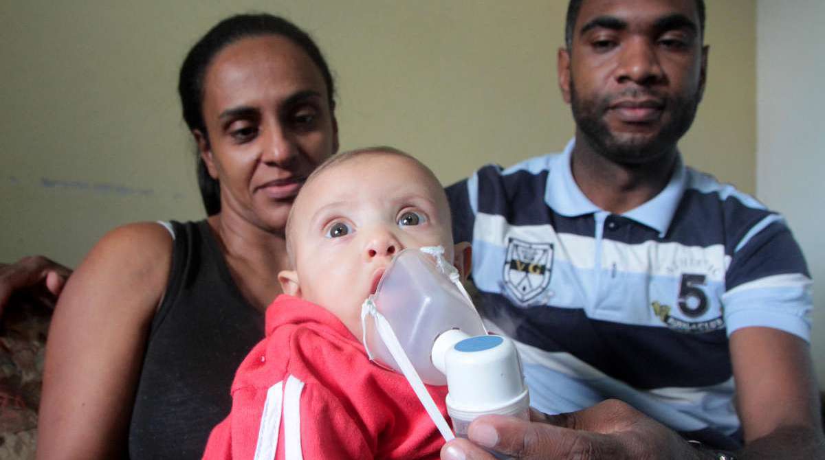 19/06/2018 - CIDADE - Suíte da série Ameaça Ambiental em Volta Redonda.Na foto: Milena de 5 meses, no colo dos pais, Keila e Dione Passos. Nebolização diária para aliviar problemas respiratórios, no Bairro Volta Grande IV.Foto: Fernanda Dias / Agência O Dia.