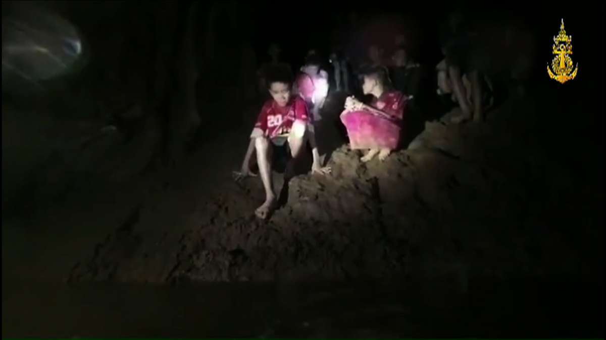 This handout video grab taken from footage released by The Royal Thai Navy late July 2, 2018, shows missing children inside the Tham Luang cave of Khun Nam Nang Non Forest Park in the Mae Sai district of Chiang Rai province.
Twelve boys and their football coach trapped in a flooded Thai cave for nine days were found alive after a painstaking search by specialist divers who finally discovered the emaciated group on a mud embankment.  AFP Photo /Royal Thai Navy