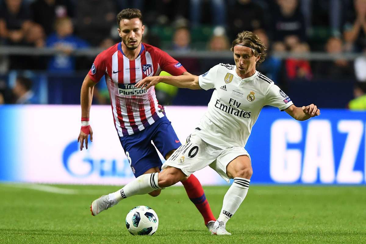 Real Madrid's Croatian midfielder Luka Modric (R) challenges Atletico Madrid's Spanish midfielder Saul Niguez during the UEFA Super Cup football match between Real Madrid and Atletico Madrid at the Lillekula Stadium in the Estonian capital Tallinn on August 15, 2018