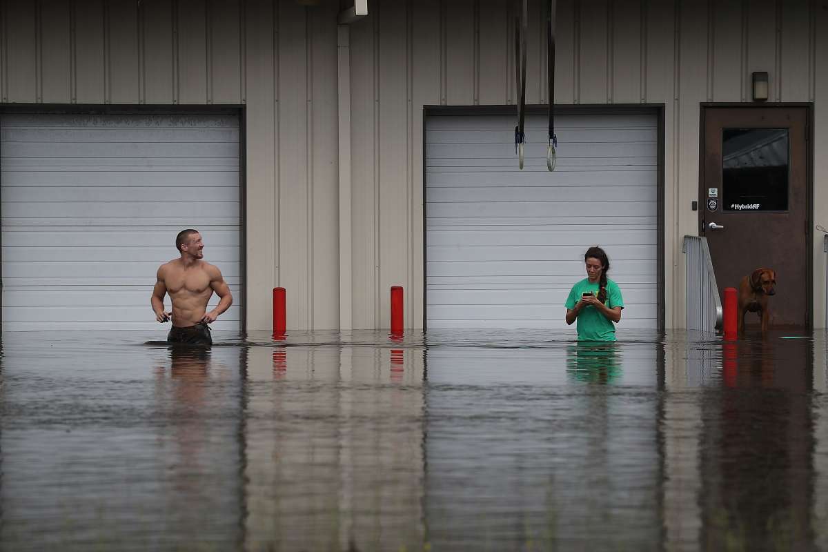 SPRING LAKE, NC - SEPTEMBER 17: Bob Richling carries Iris Darden as water from the Little River starts to seep into her home on September 17, 2018 in Spring Lake, North Carolina. Pam Darden and Iris Darden's son, David Darden jr., help save items from the home as flood waters from the cresting rivers inundate the area after the passing of Hurricane Florence.   
      Caption