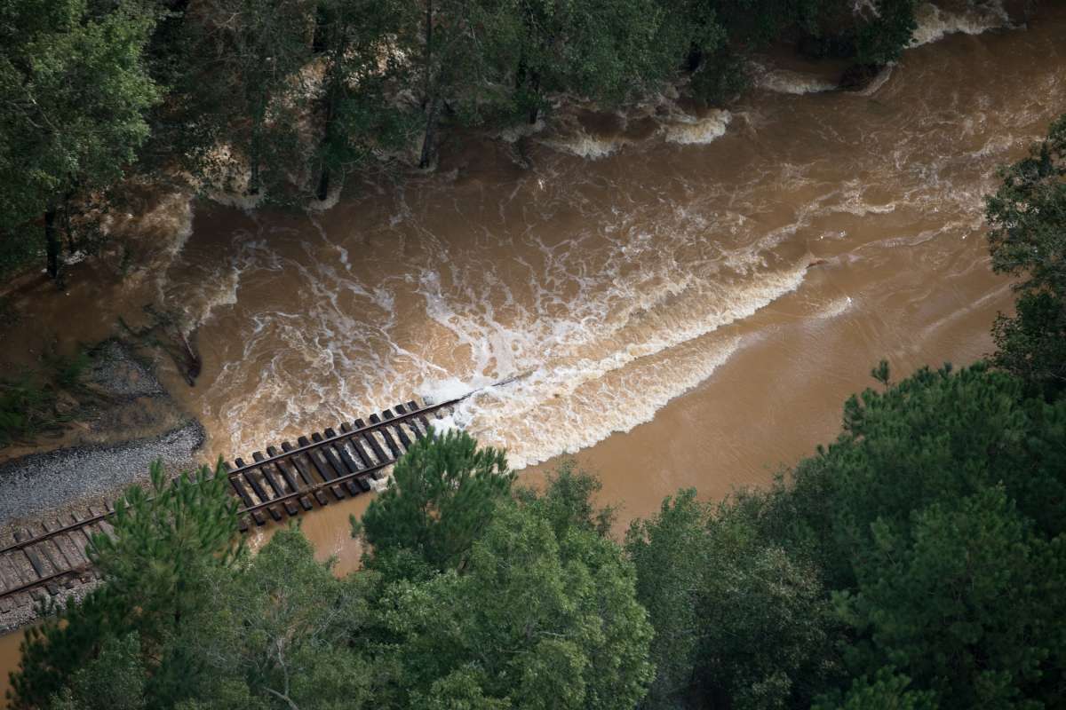 SPRING LAKE, NC - SEPTEMBER 17: Bob Richling carries Iris Darden as water from the Little River starts to seep into her home on September 17, 2018 in Spring Lake, North Carolina. Pam Darden and Iris Darden's son, David Darden jr., help save items from the home as flood waters from the cresting rivers inundate the area after the passing of Hurricane Florence.   
      Caption