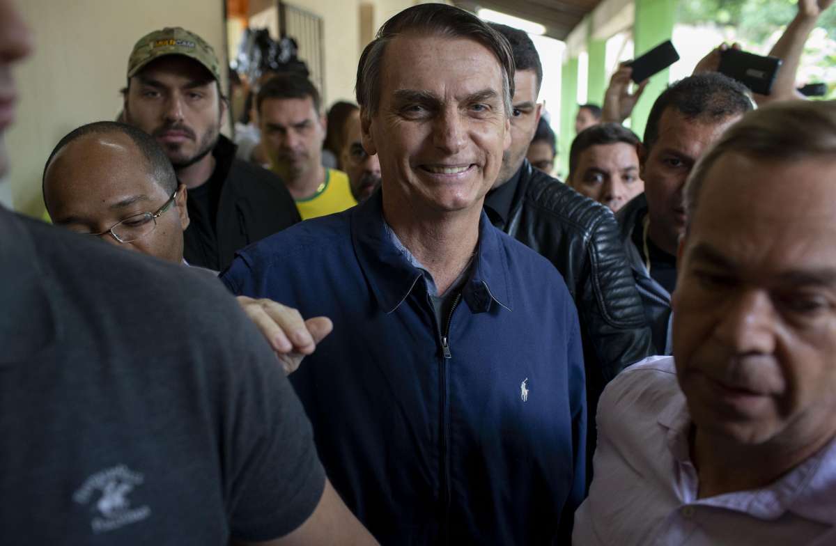 Brazil's right-wing presidential candidate for the Social Liberal Party (PSL) Jair Bolsonaro (C) leaves after casting his vote during the general elections, in Rio de Janeiro, Brazil, on October 7, 2018.
Brazilians began casting ballots Sunday in their most divisive presidential election in years, with a far-right politician promising an iron-fisted crackdown on crime, Jair Bolsonaro, the firm favorite in the first round. AFP PHOTO / Mauro Pimentel