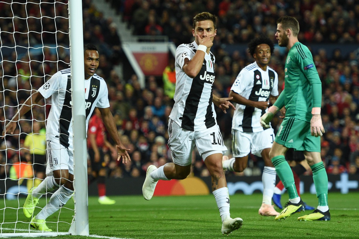 Juventus' Argentinian striker Paulo Dybala (C) celebrates after scoring the opening goal of the Champions League group H football match between Manchester United and Juventus at Old Trafford in Manchester, north west England, on October 23, 2018. (Photo by Oli SCARFF / AFP)