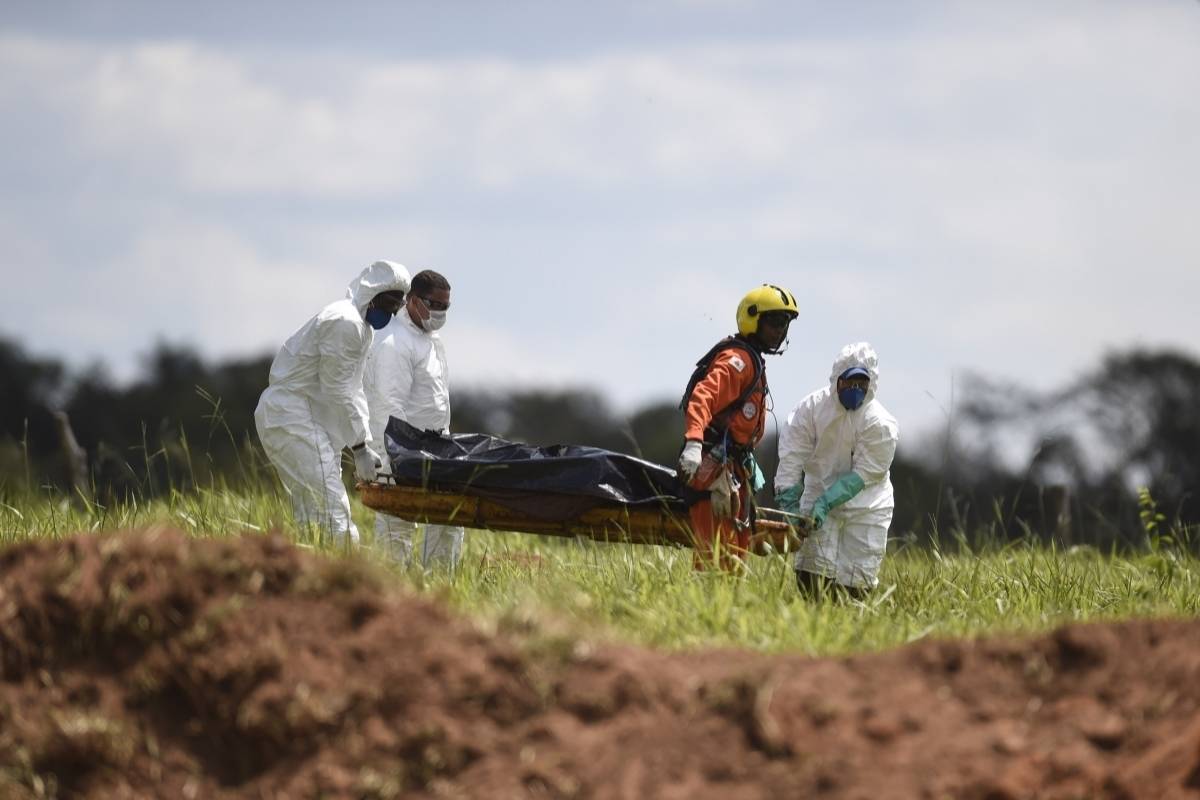 Equipes de resgate carregam um corpo recuperado após o colapso da barragem de sexta-feira em Córrego do Feijão, perto da cidade de Brumadinho