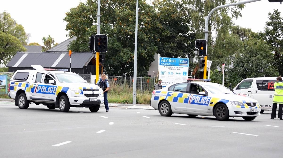 This picture released by Radio New Zealand shows police officers cordoning a street near the mosque after a firing incident in Christchurch on March 15, 2019. - A gunman opened fire inside the Masjid al Noor mosque during afternoon prayers, causing multiple fatalities. (Photo by - / RADIO NEW ZEALAND / AFP) / New Zealand OUT / XGTY----EDITORS NOTE ----RESTRICTED TO EDITORIAL USE MANDATORY CREDIT " AFP PHOTO /RADIO NEW ZEALAND / NO MARKETING NO ADVERTISING CAMPAIGNS - DISTRIBUTED AS A SERVICE TO CLIENTS- NO ARCHIVE