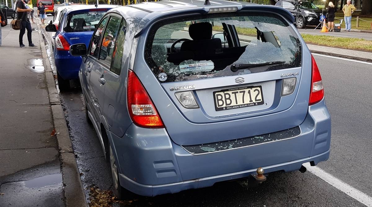 A car with shattered windows is parked close to the mosque after a gunman filming himself firing at worshippers inside in Christchurch on March 15, 2019. - A gunman opened fire inside the Masjid al Noor mosque during afternoon prayers, causing multiple fatalities. (Photo by Flynn FOLEY / AFP)