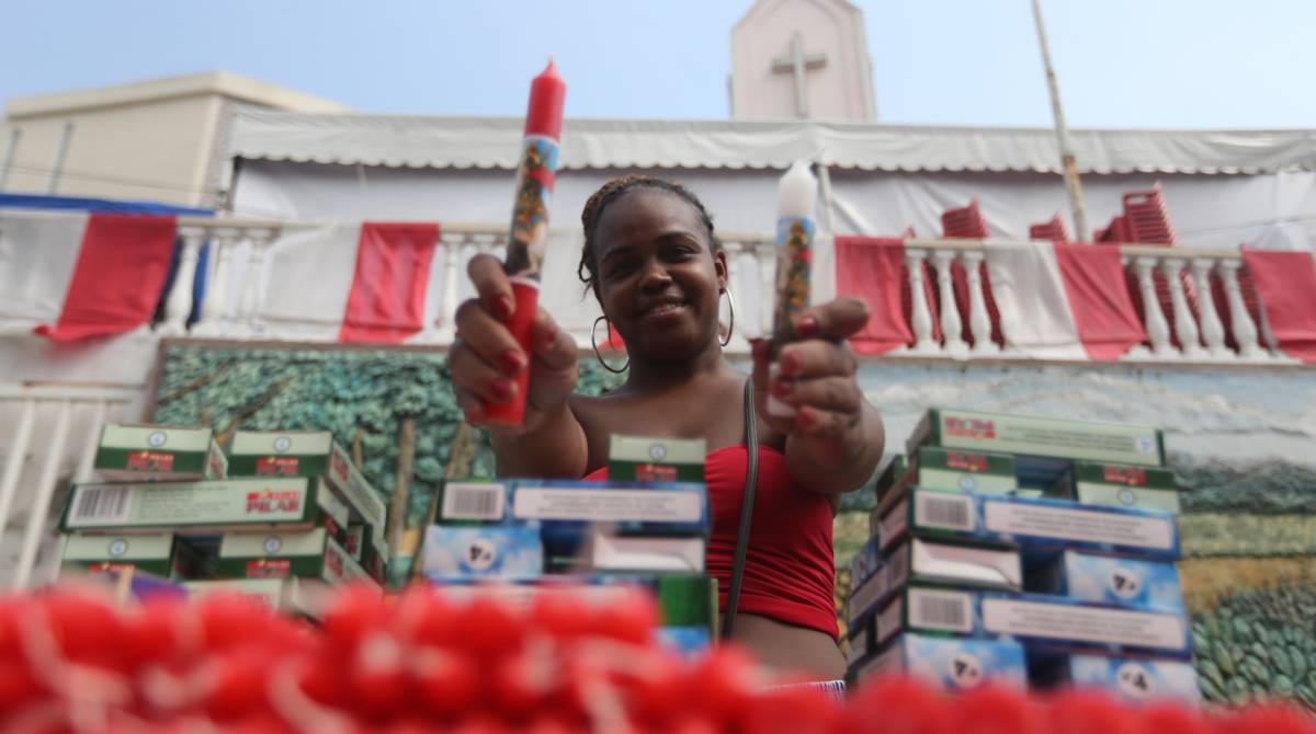 No dia de São Jorge, fiéis que veneram o Santo Guerreiro vão na igreja em Quintino. Santo de todos os credos, é louvado na Igreja Católica, Candomblé e Umbanda. São Jorge é cotado para dividir o título de padroeiro do Estado do Rio com São Sebastião. Na foto Nayara Matheus vendedora de velas. Foto: Daniel Castelo Branco / Agência O Dia
