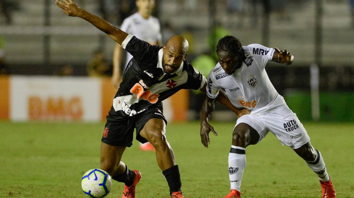 Fellipe Bastos tenta proteger a bola de Chará, que fez o gol da vitória do Galo no fim - Armando Paiva / Agência O Dia