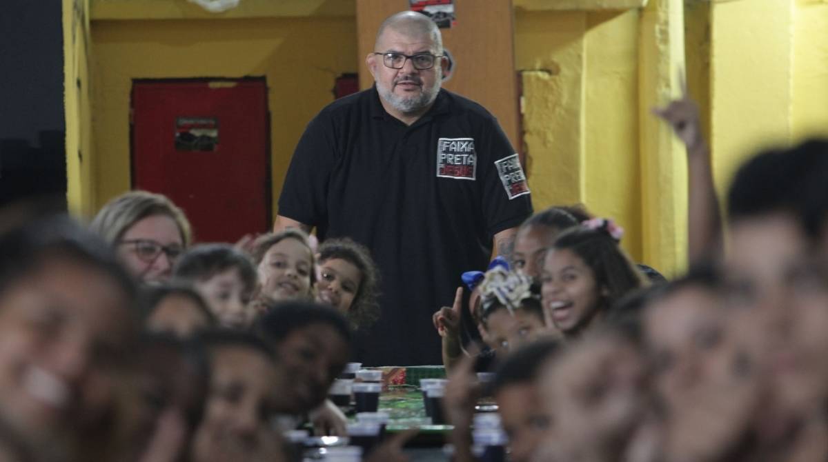 Ricardo Cavalcante se alegra com a distribuição de pratos de comida a alunos do projeto social. Por mês, o Faixa Preta de Jesus distribui 3 mil refeições - Fotos de Ricardo Cassiano