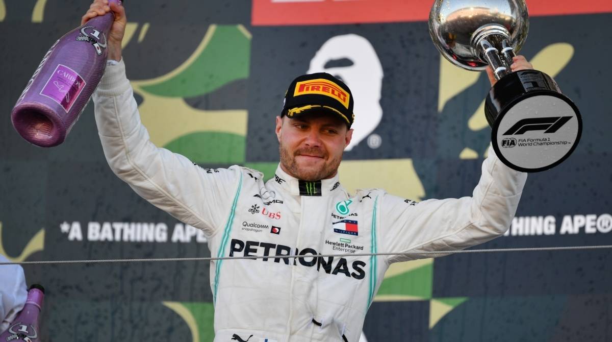 Mercedes' Finnish driver Valtteri Bottas celebrates his victory on the podium after the finish of the Formula One Japanese Grand Prix final at Suzuka on October 13, 2019. (Photo by Toshifumi KITAMURA / AFP)