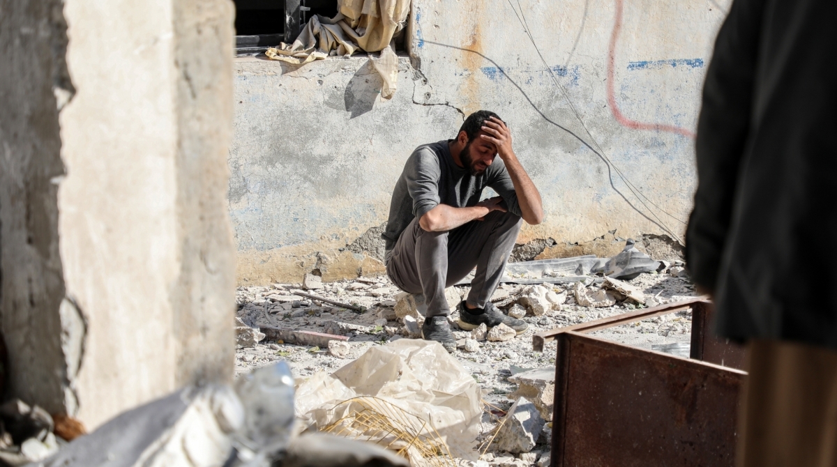 A man crouches as he reacts following a car bomb explosion at the industrial zone in the northern Syrian town of Tal Abyad, on the border with Turkey, on November 23, 2019. - Several people were killed, including civilians, over a dozen injured by the blast in the Turkish-controlled northern Syrian town. Turkey and its Syrian proxies control several pockets of territory on the Syrian side of the border as a result of successive incursions in 2016-17, 2018 and 2019. (Photo by Zein Al RIFAI / AFP)