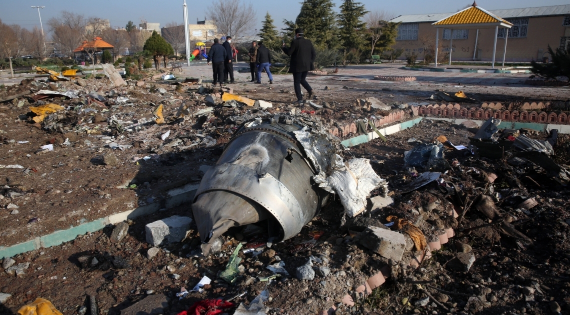 Rescue teams work amidst debris after a Ukrainian plane carrying 176 passengers crashed near Imam Khomeini airport in the Iranian capital Tehran early in the morning on January 8, 2020, killing everyone on board. - The Boeing 737 had left Tehran's international airport bound for Kiev, semi-official news agency ISNA said, adding that 10 ambulances were sent to the crash site. (Photo by - / AFP) - AFP