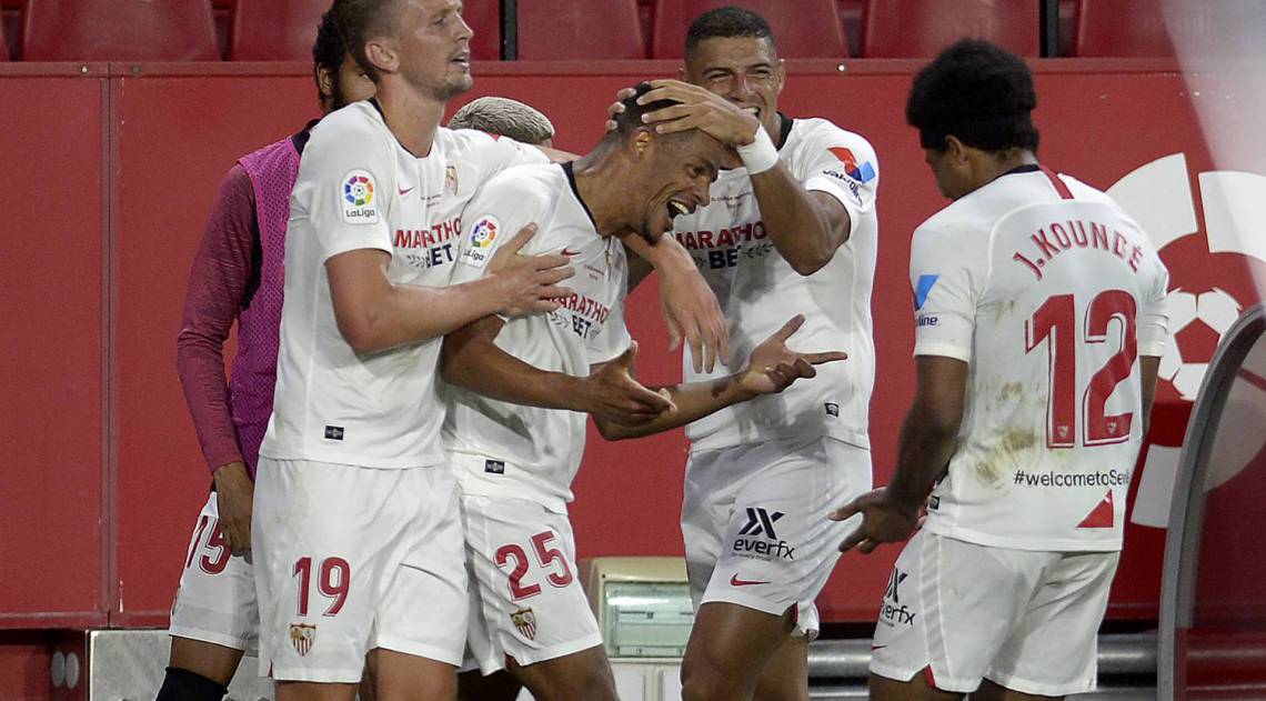 Sevilla's Brazilian midfielder Fernando (C) celebrates with teammates after scoring a goal during the Spanish League football match between Sevilla FC and Real Betis at the Ramon Sanchez Pizjuan stadium in Seville on June 11, 2020