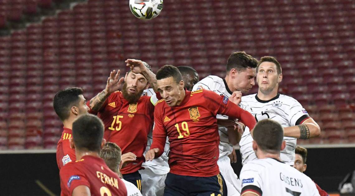 Spain's defender Sergio Ramos (L) and Spain's forward Rodrigo (C) vie for the ball during the UEFA Nations League football match between Germany and Spain in Stuttgart, southern Germany, on September 3, 2020. (Photo by THOMAS KIENZLE / AFP)
Caption
