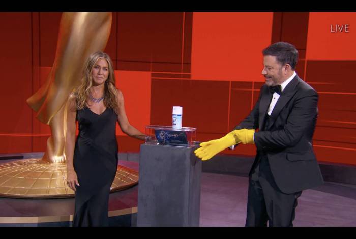 Jennifer Aniston desinfetando as fichas do Emmy durante a cerimônia que aconteceu na noite deste domingo - AFP