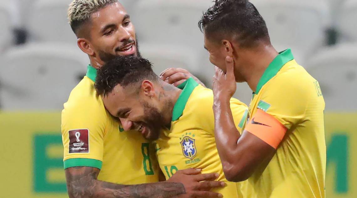 Brazil's Neymar (C) celebrates with teammates Douglas Luiz (L) and Thiago Silva a goal scored by Philippe Coutinho (not depicted), during the 2022 FIFA World Cup South American qualifier football match against Bolivia at the Neo Quimica Arena, also known as Itaquerao, in Sao Paulo, Brazil, on October 9, 2020, amid the COVID-19 novel coronavirus pandemic. (Photo by AMANDA PEROBELLI / POOL / AFP)