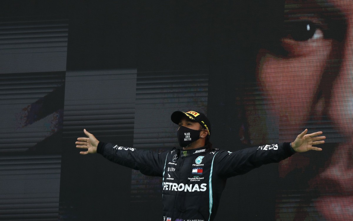 Mercedes' British driver Lewis Hamilton celebrates on the podium after winning the Portuguese Formula One Grand Prix at the Autodromo Internacional do Algarve on October 25, 2020 in Portimao. (Photo by RAFAEL MARCHANTE / POOL / AFP)