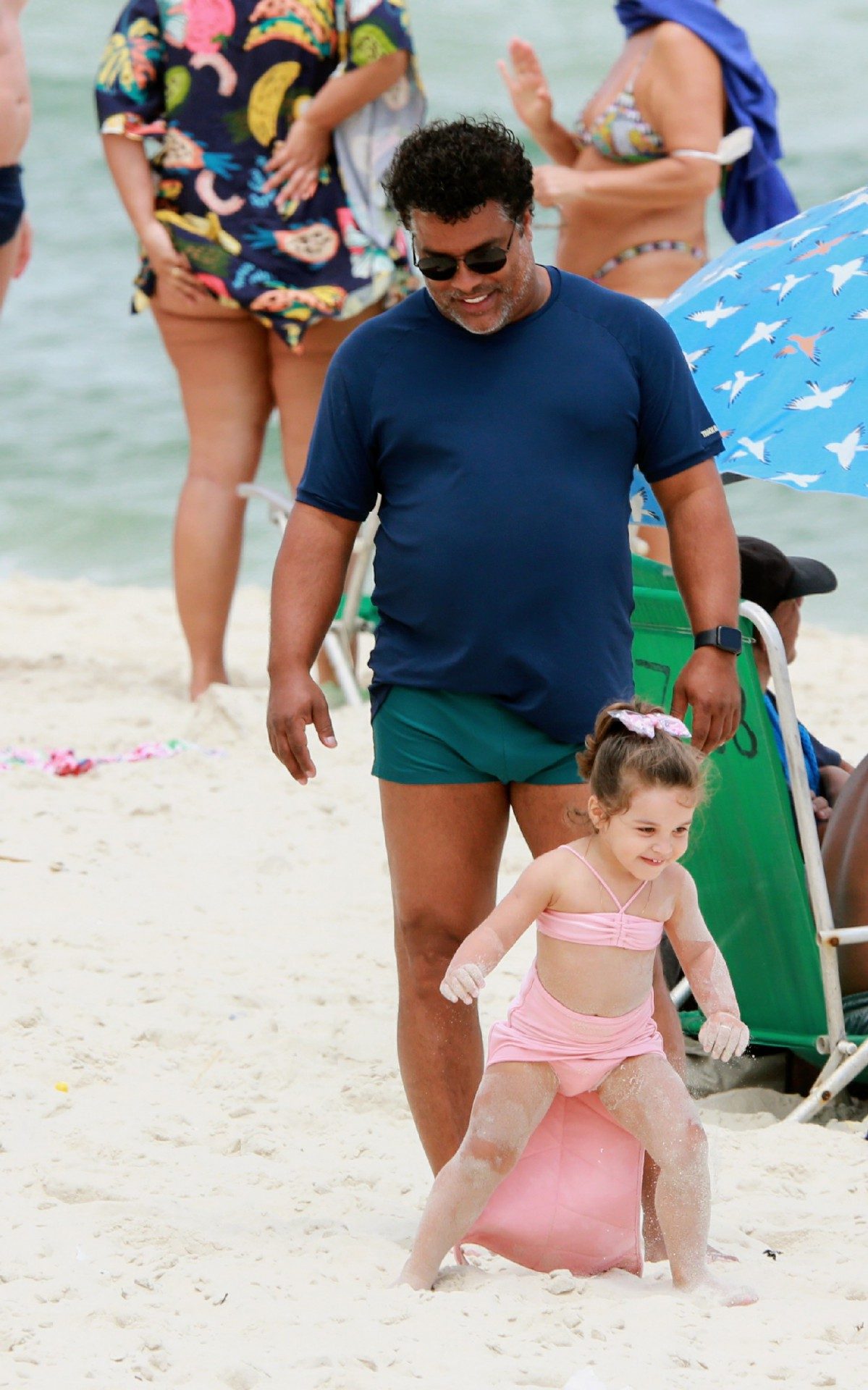 Roberto de Assis brinca com a filha na praia
