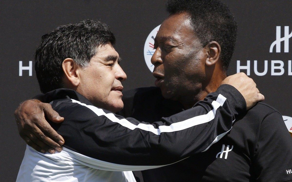 (FILES) In this file photo taken on June 09, 2016 former Argentinian football international Diego Maradona (L) and former Brazilian footballer Pele pose after a football match organised by Swiss luxury watchmaker Hublot at the Jardin du Palais Royal in Paris, on the eve of the Euro 2016 European football championships. - Argentinian football legend Diego Maradona passed away on November 25, 2020. (Photo by PATRICK KOVARIK / AFP)