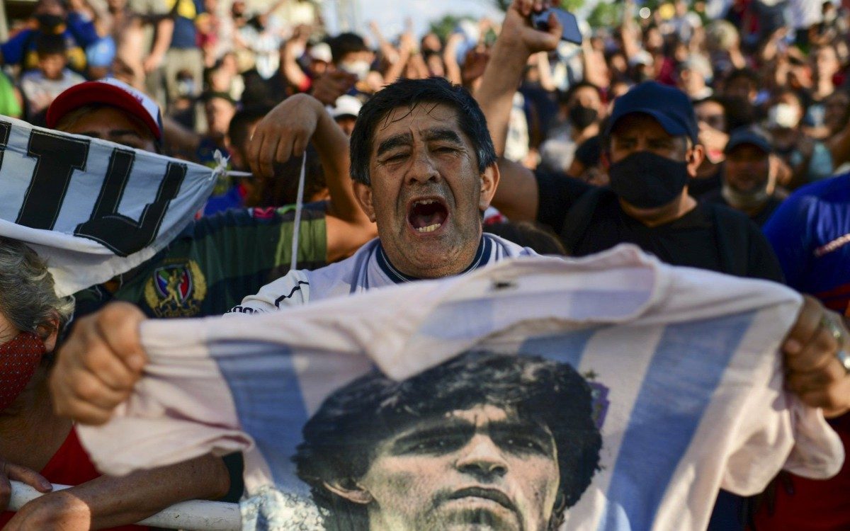 Fans gather outside the morgue where the late Argentine football star Diego Maradona's body will undergo an autopsy 