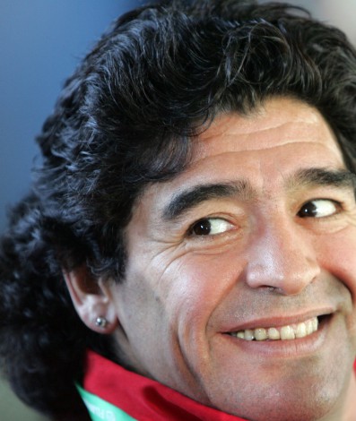(FILES) In this file photo taken on June 23, 2006 Argentinian football legend and part-time television sports commentator Diego Maradona smiles while watching action from the press tribune during the opening round Group H World Cup football match between Saudi Arabia and Spain at Kaiserslautern's Fritz-Walter Stadium. - Argentine football legend Diego Maradona has died at the age of 60, his spokesman announced on November 25, 2020. (Photo by Roberto SCHMIDT / AFP) - AFP
