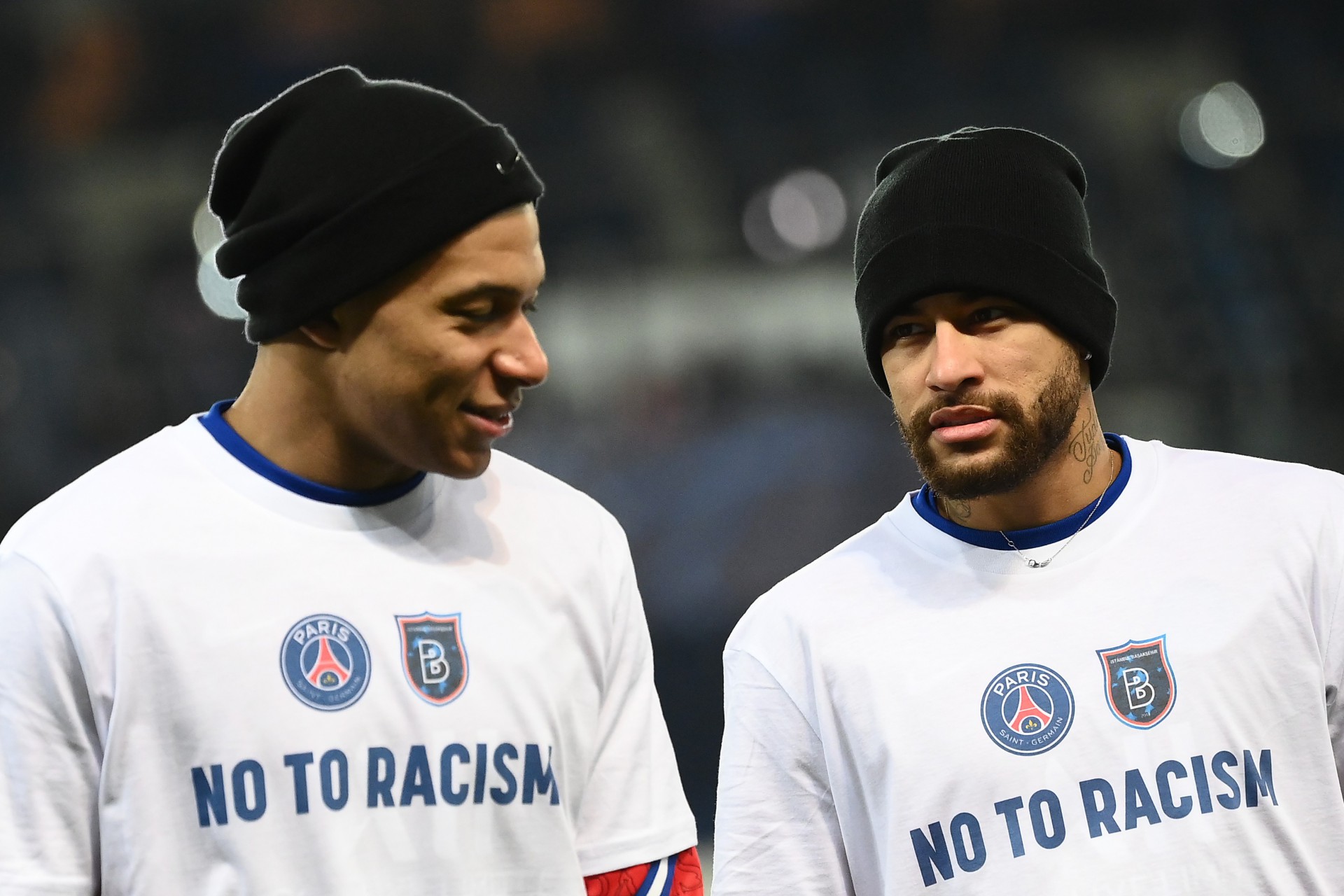 Paris Saint-Germain's French forward Kylian Mbappe (L) and Paris Saint-Germain's Brazilian forward Neymar, wearing tshirt reading 