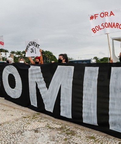 Demonstrators hold a banner reading 