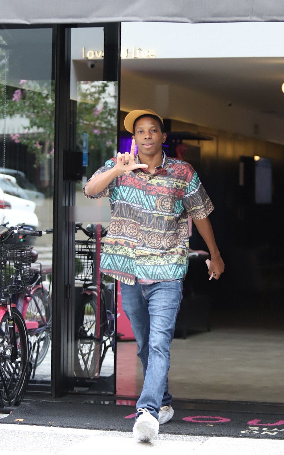 Lucas Penteado deixa hotel em São Paulo acompanhado por uma prima